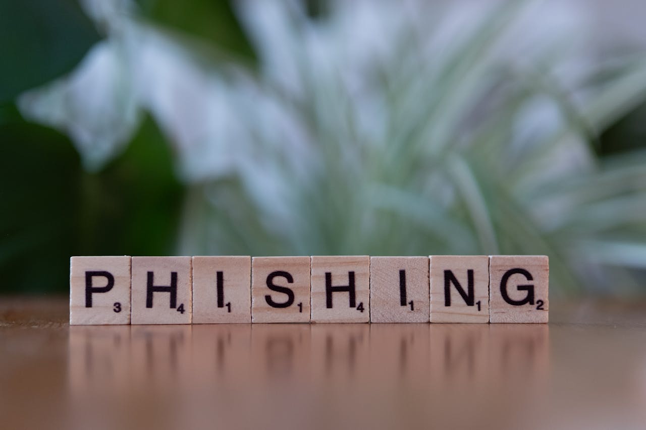 services-img Wooden tiles spelling 'phishing' highlight cybersecurity themes.